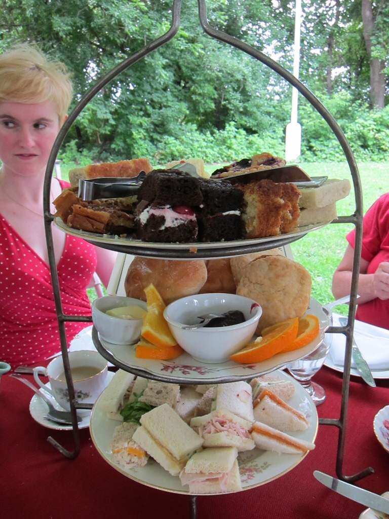 3 plates piled high with tasty afternoon tea snacks.